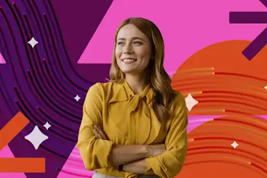 A smiling woman in a yellow blouse stands with arms crossed against a vibrant pink, purple, and orange graphic background.