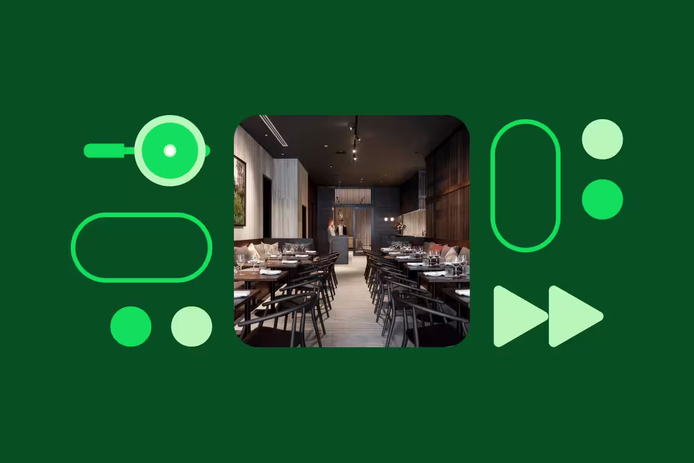 A restaurant interior with dark wood tables and chairs on a green background with decorative graphic shapes.
