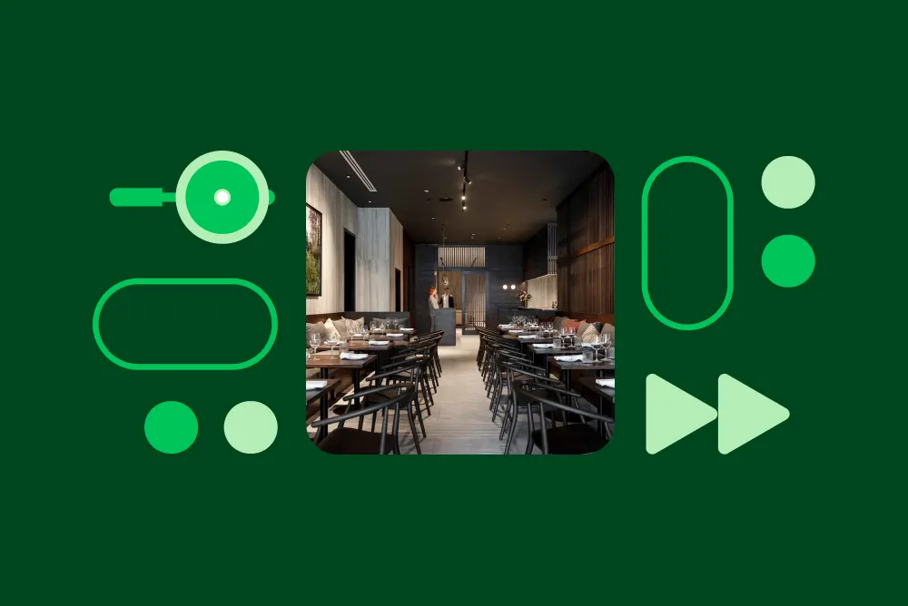 A restaurant interior with dark wood tables and chairs on a green background with decorative graphic shapes.