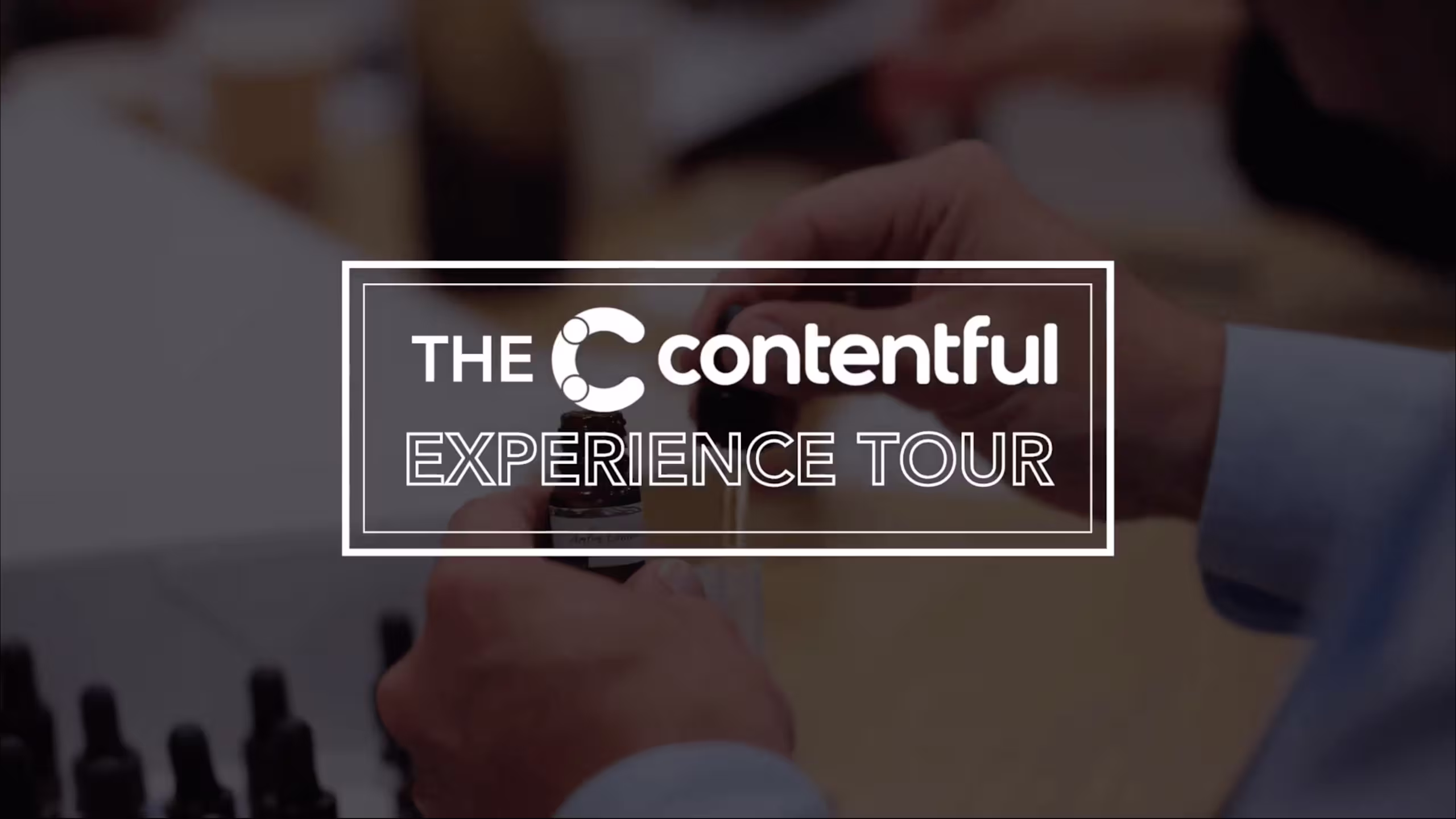 White text logo reading "THE contentful EXPERIENCE TOUR" on a blurred background with rectangular frame design