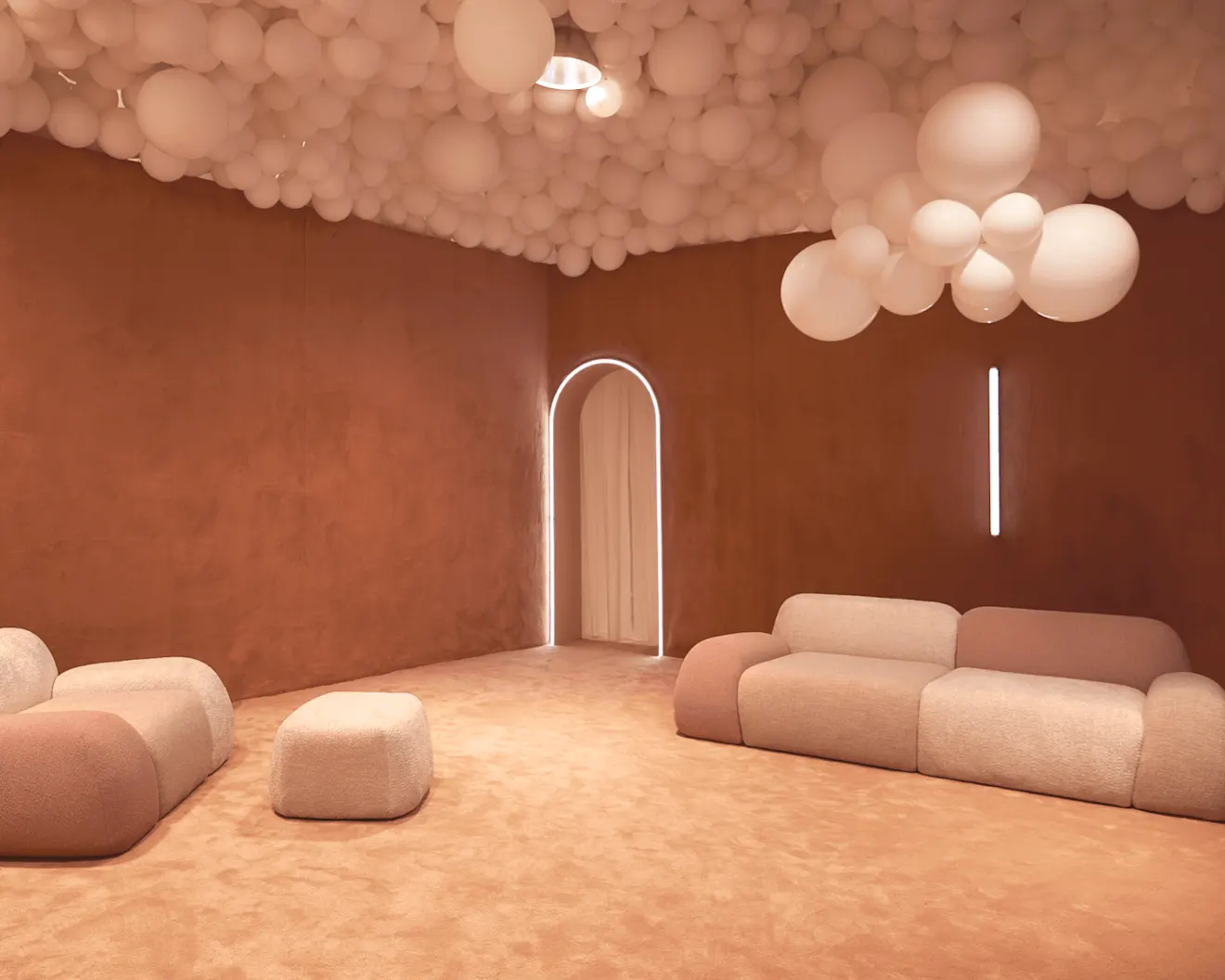 A terracotta room with cream balloon ceiling installation, modular sofas, a glowing arched doorway, and soft ambient lighting.