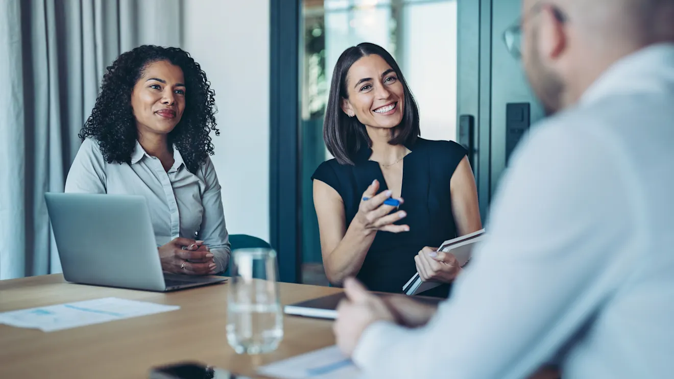 Two financial consultants are working with a client.