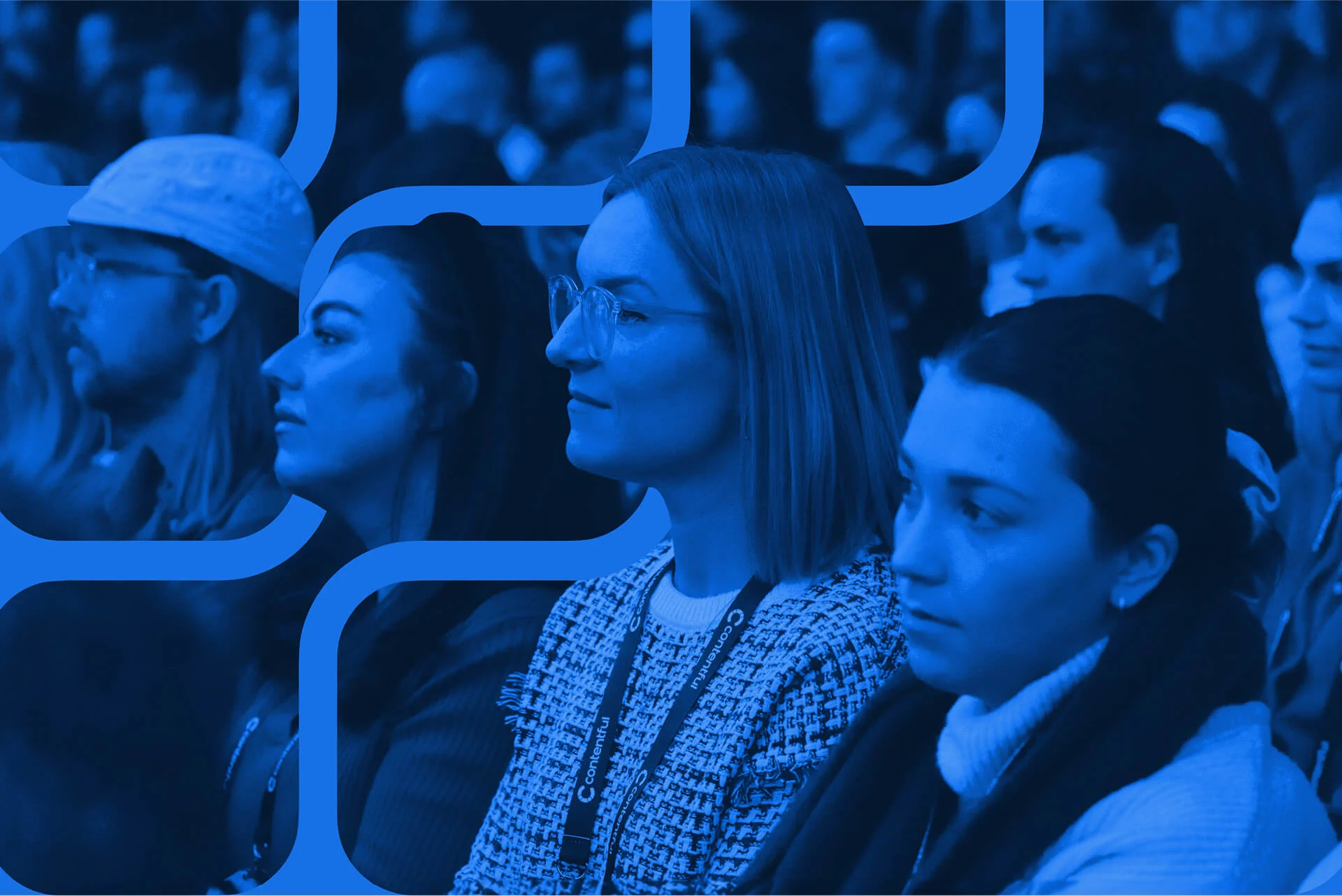 A crowd of pleasant looking people looking intently at the Contentful event they are watching