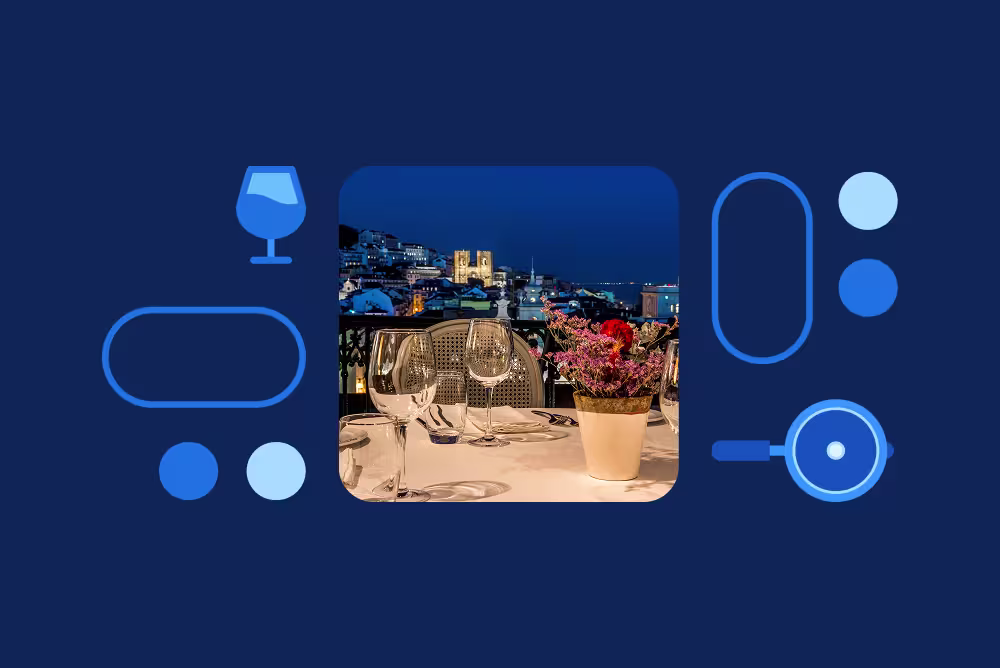 An elegant rooftop dinner table with wine glasses and flowers, overlooking a lit cityscape at night, framed by blue icons.