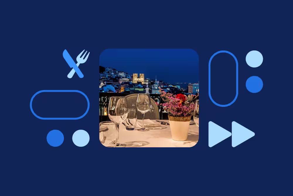 An elegant rooftop dinner table with wine glasses and flowers, overlooking a lit cityscape at night, framed by blue icons.