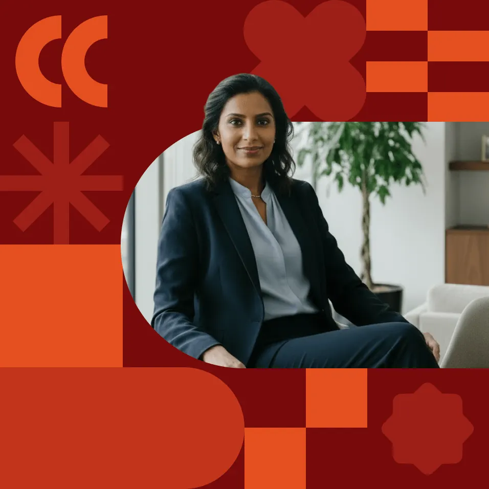 A professional woman in a dark blazer sits confidently in an office, framed by a bold red graphic background with decorative shapes.