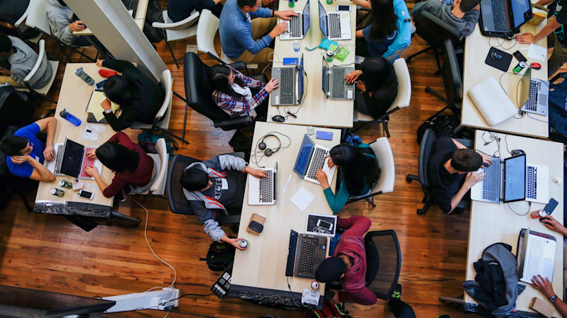 Overhead shot of workers on their laptops in an office
