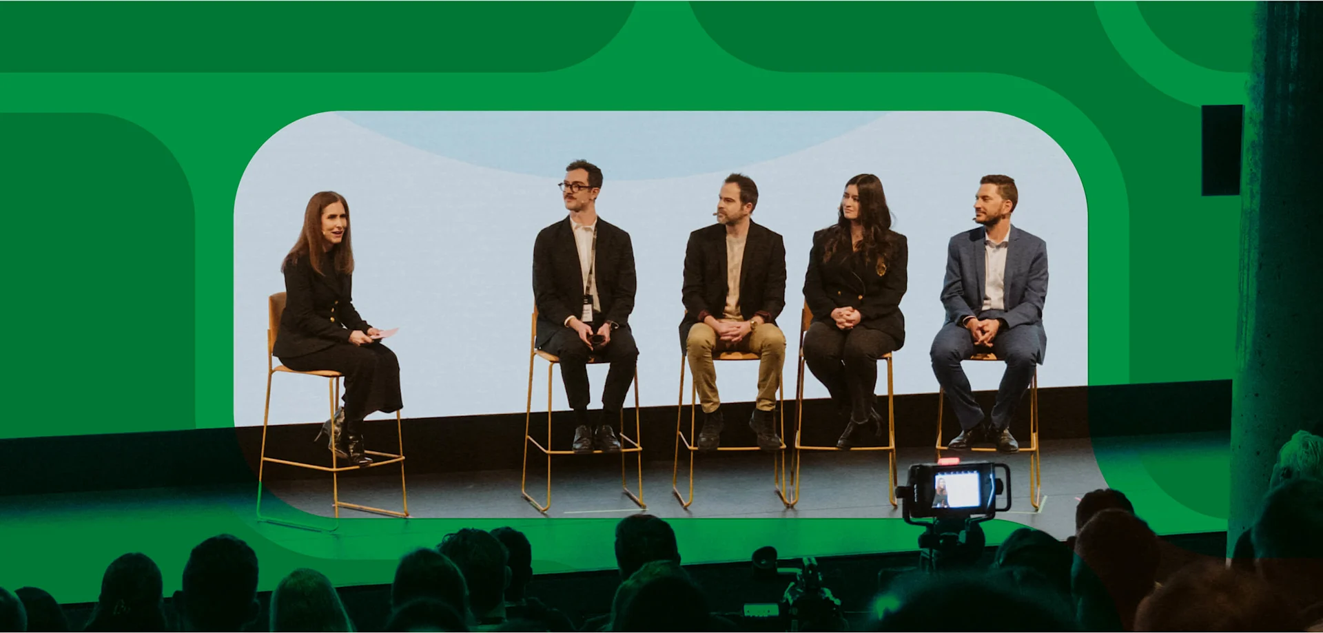 Four panelists on Contentful's stage with a host in front of green contentful iconography